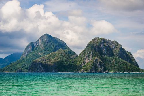 Free Breathtaking view of El Nido's limestone cliffs surrounded by blue ocean. Stock Photo