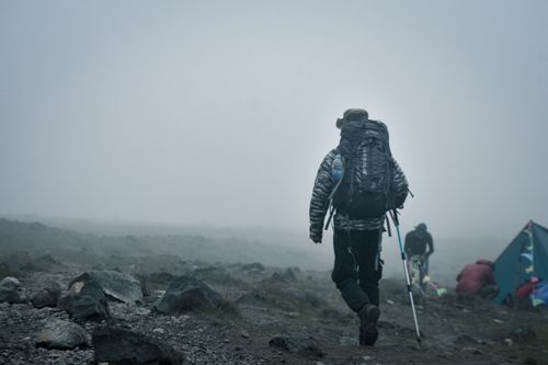 Free A hiker with gear treks through a foggy mountain landscape in Jawa Barat, Indonesia. Stock Photo