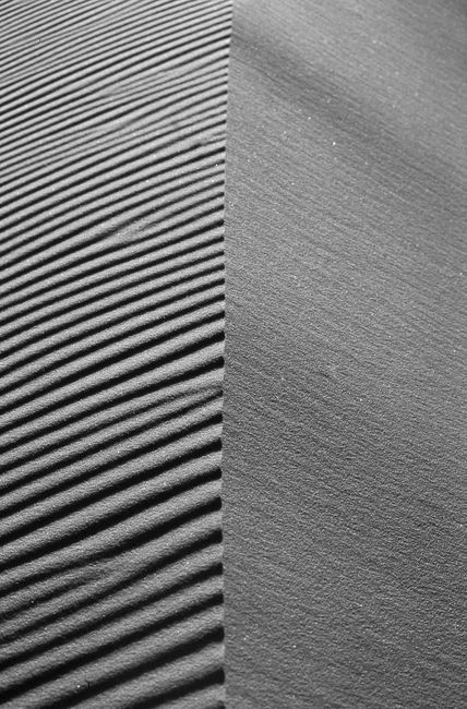 Black and white abstract view of sand dunes in Merzouga, Morocco, showcasing unique textures.