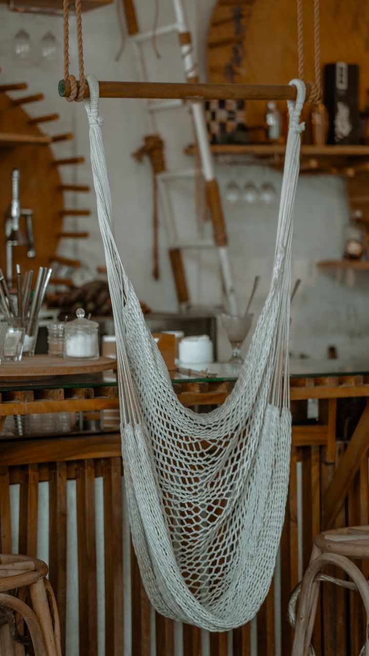 Small natural jute woven rug layered under a boho coffee bar counter with a rattan cart on top