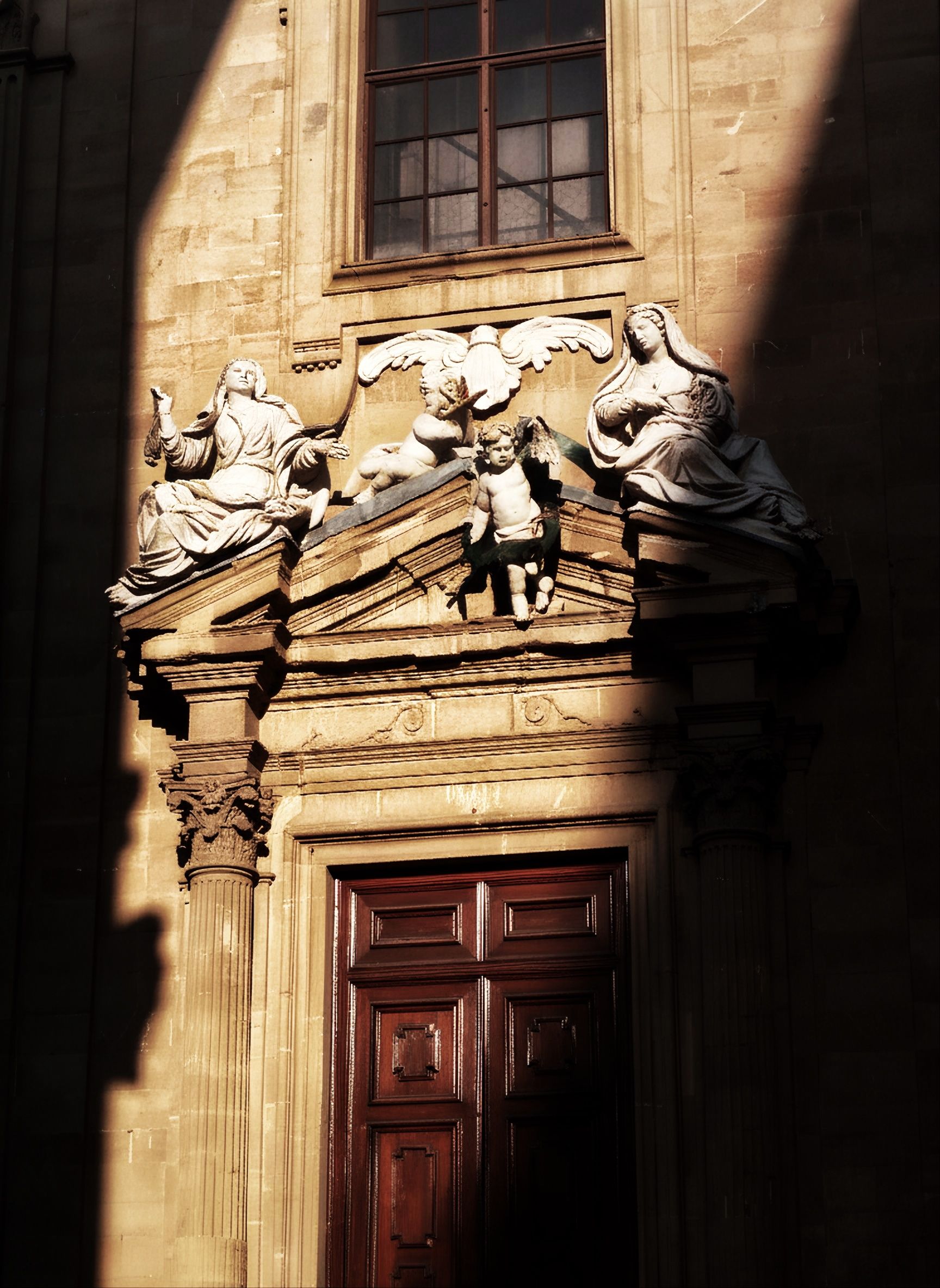 Historic Stone Facade with Sculptures in Sunlight · Free Stock Photo
