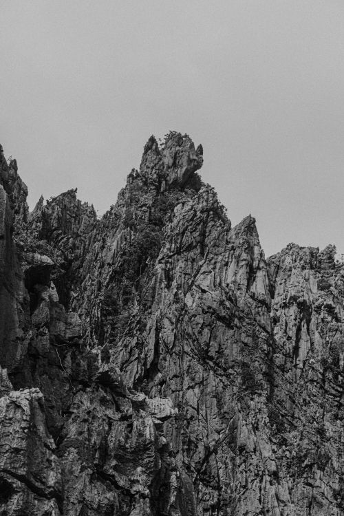 Free Black and white photo of rugged mountain peaks with dramatic texture. Stock Photo