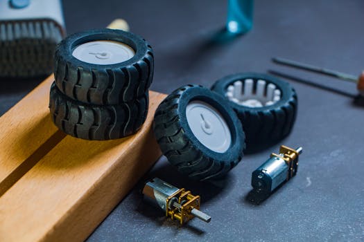 Close-up of robotics kit parts including wheels and motors for tech projects.