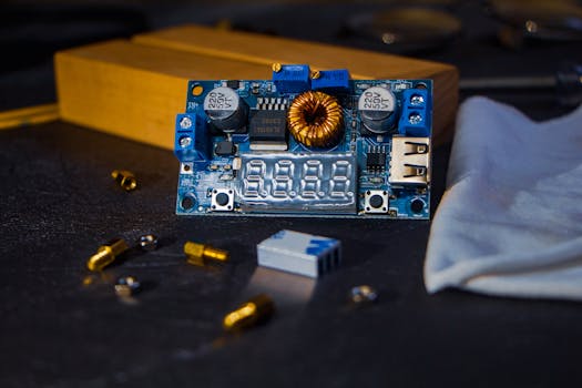 Close-up of an electronic circuit board with various components on a dark background. Ideal for tech themes.