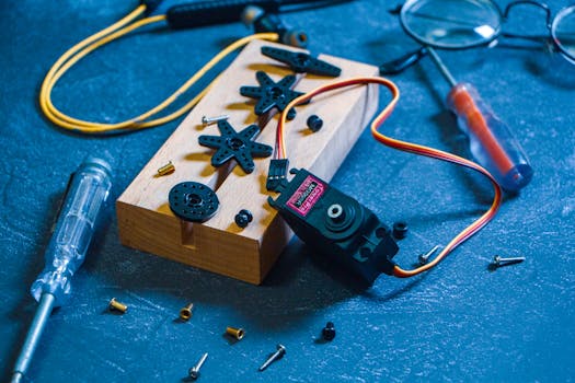 Detailed view of robotics components and tools on a workbench, showcasing innovation and technology.