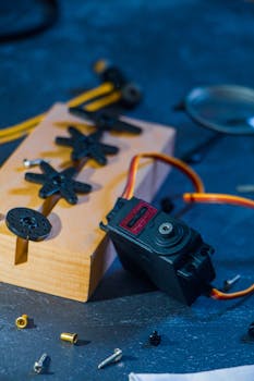 Close-up of robotics kit parts on a table, showcasing innovation and technology.