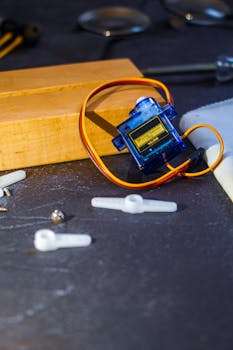 Detailed shot of a servo motor and components, ideal for tech and robotics projects.