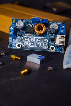 Detailed shot of a circuit board with electronic components including capacitors and digital display.