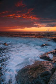 Captivating sunset with vibrant colors over the rocky shoreline of Fındıklı, Rize, Türkiye.