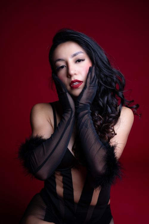 Free Striking fashion portrait of a woman in elegant attire with black gloves. Stock Photo
