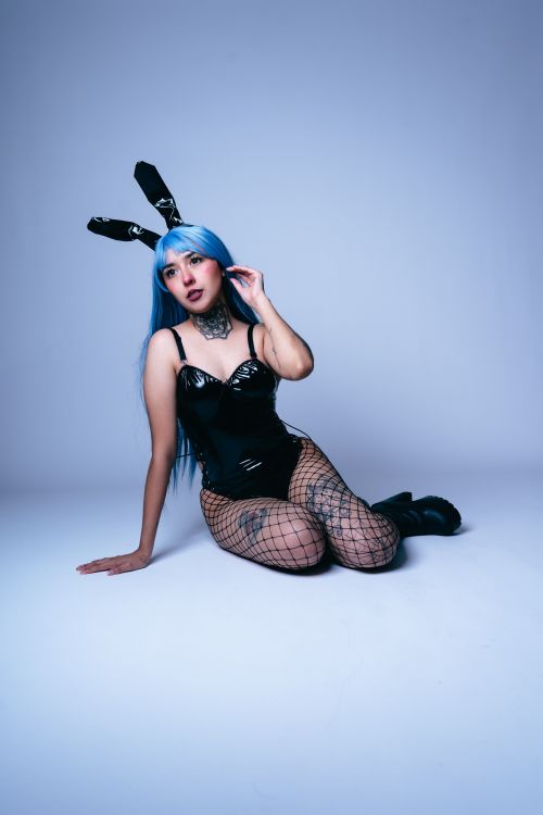 Free Vivid cosplay of anime character wearing bunny ears and blue wig in a striking pose. Stock Photo
