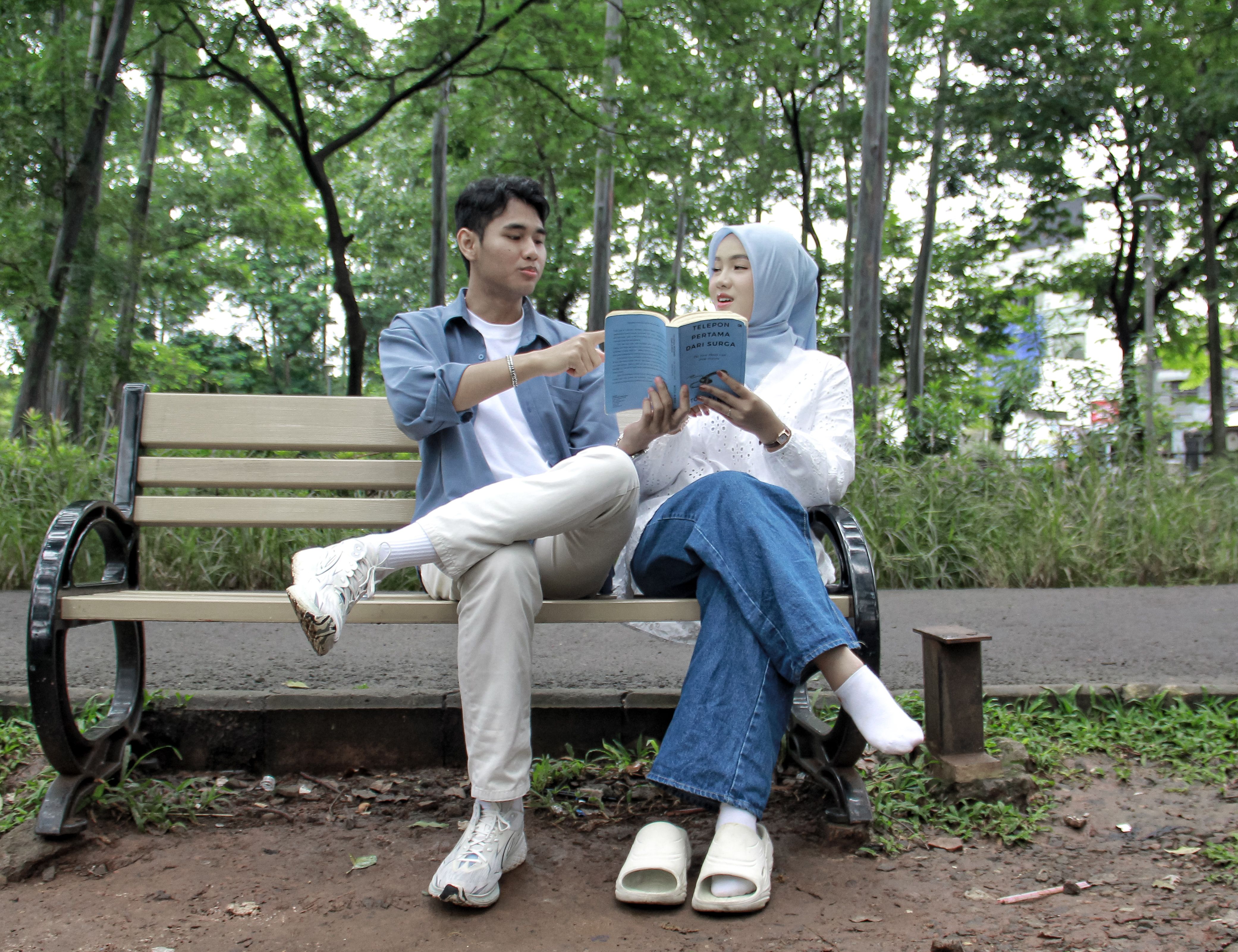 Young Couple Reading Together in Jakarta Park