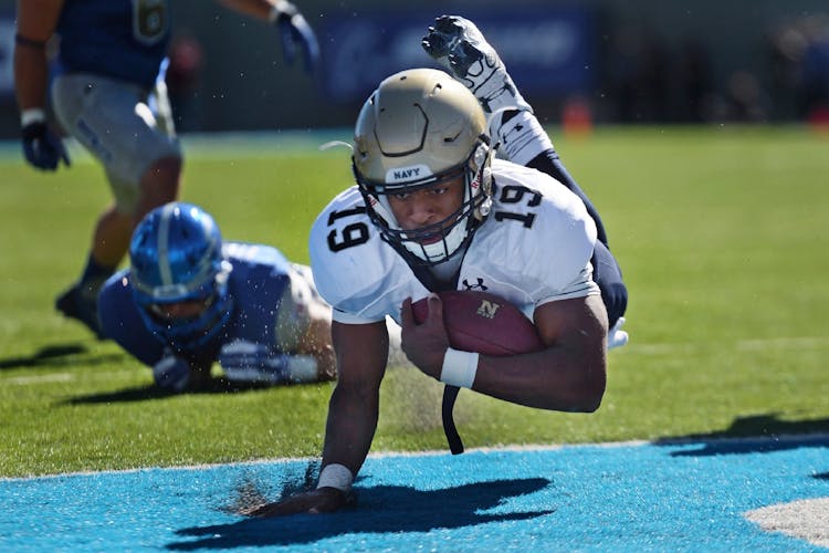 Football Player Diving Towards The Goal