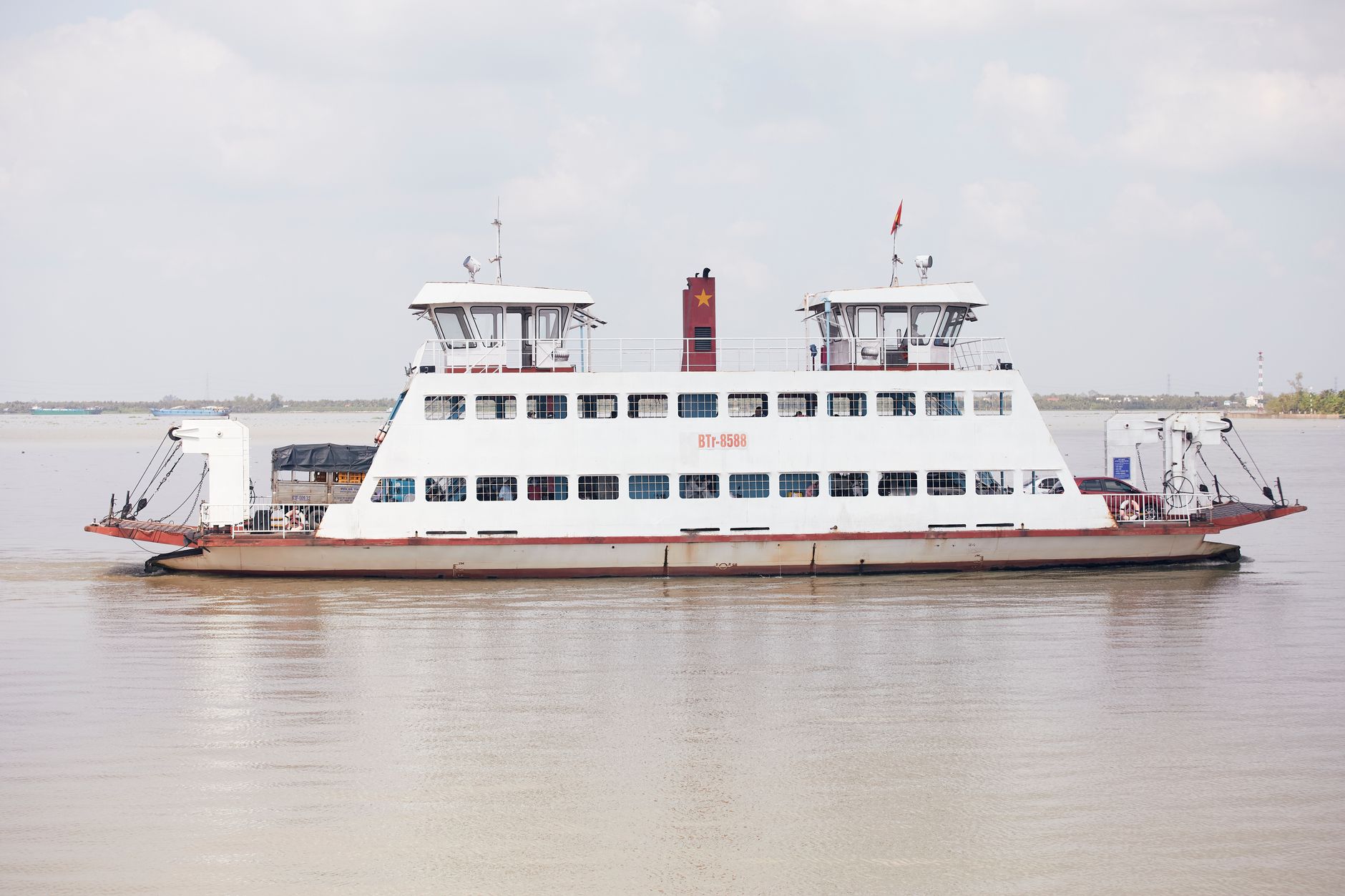 Ferry transporting vehicles and people across the Mekong River in Vietnam.