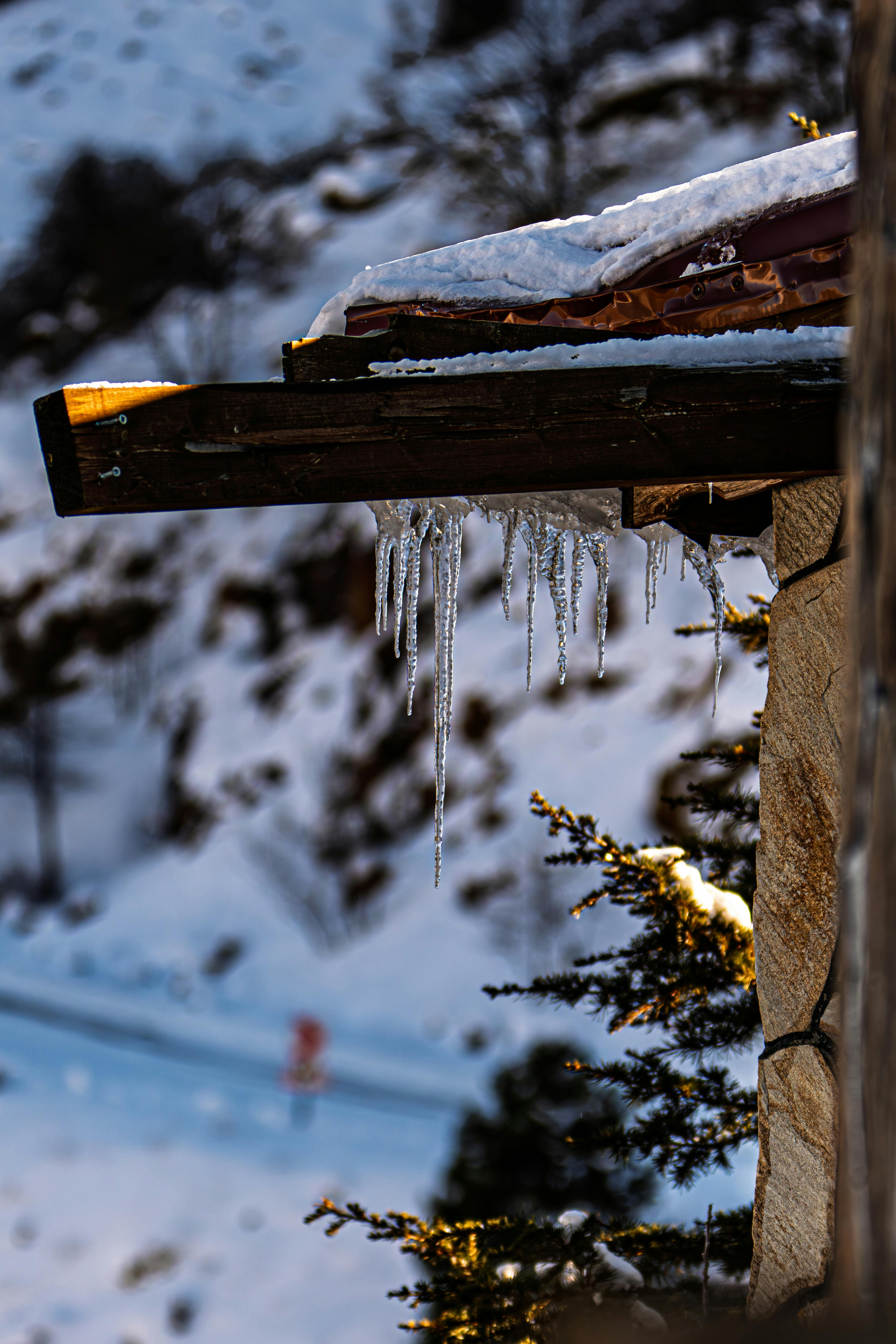 Icicles hanging from a roof in a snowy winter scene in Çelikhan, Adıyaman, Türkiye.