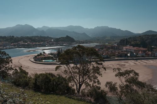 Free A beautiful landscape of Ribadesella beach with surrounding mountains in Asturias, Spain. Stock Photo