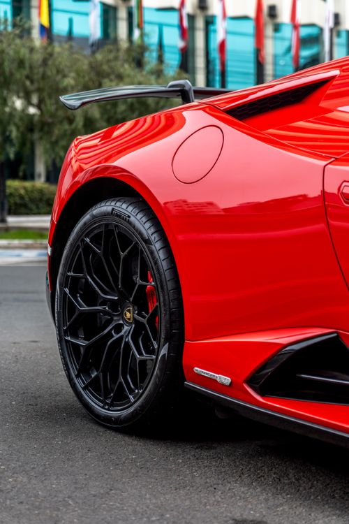Free Close-up of a red sports car with stylish wheels, captured outdoors. Stock Photo