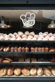 Explore the delightful display of baked goods at St Ives Bakery with fresh loaves and pastries.