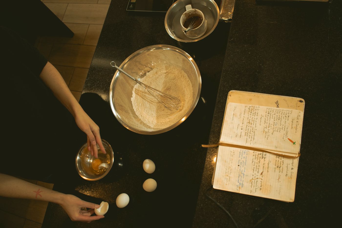 Baking ingredients and an open recipe book arranged in a bright home kitchen