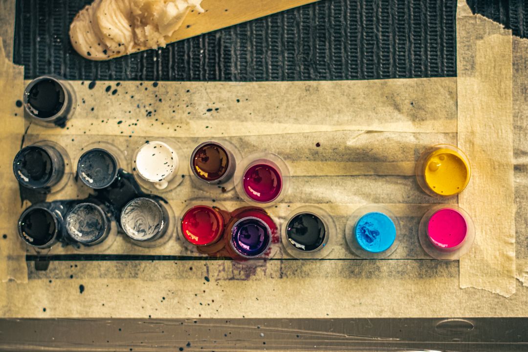 Tattoo ink cups in vibrant colors set on a studio workstation in Ciudad de México.