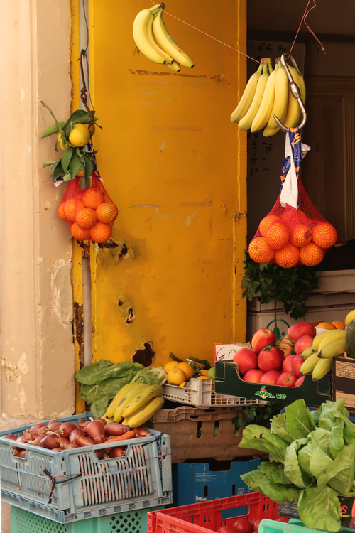 Free Colorful display of fresh fruits at an outdoor market stall in Malta. Stock Photo