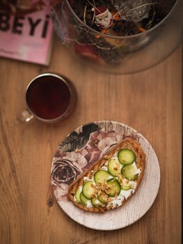 Rustic cucumber toast with tea on a wooden table, adding charm to a quiet afternoon.