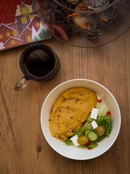 Warm festive meal with salad, wine, and holiday decor, perfect for cozy gatherings.