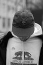 Grayscale Photo of Person Wearing Black Cap and White Jacket