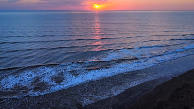 A calm and scenic sunrise over the coastal waters of Costa Azul, Argentina.