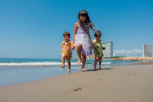 Three kids enjoy a sunny day on the beach, capturing the essence of summer fun and happiness.