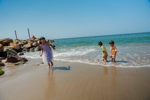 Joyful children playing by the sea on a sunny day, capturing carefree summer fun.