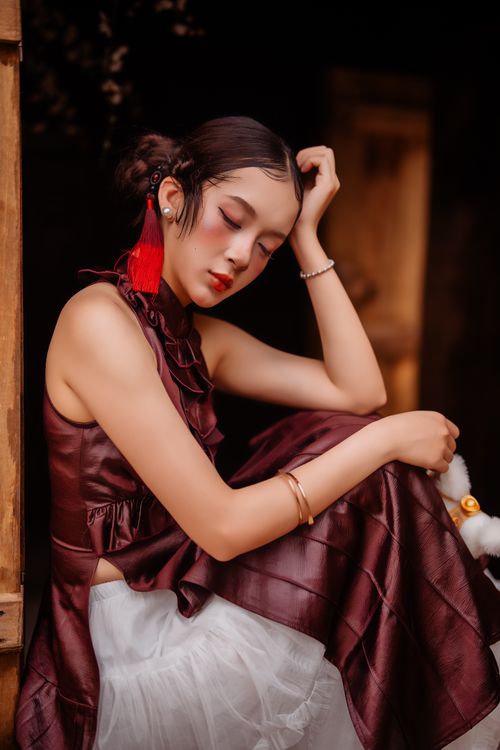 Elegant Woman in Silk Dress Resting Indoors · Free Stock Photo