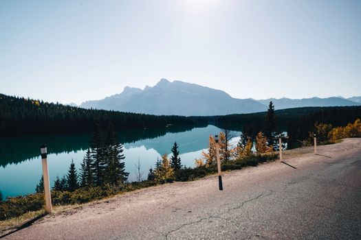 Breathtaking view of a serene lake surrounded by forest and mountains in Canada.