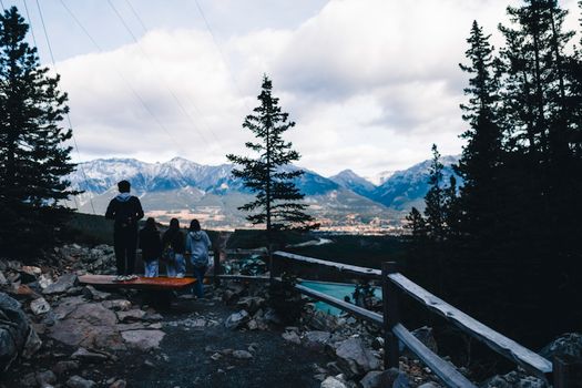 Group enjoying majestic mountain view from a lookout in Canadian wilderness, perfect for adventure and travel themes.