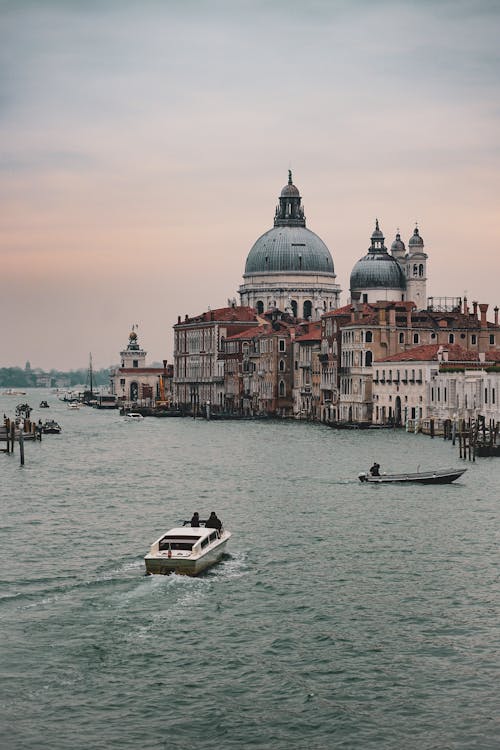 People Sailing towards Building