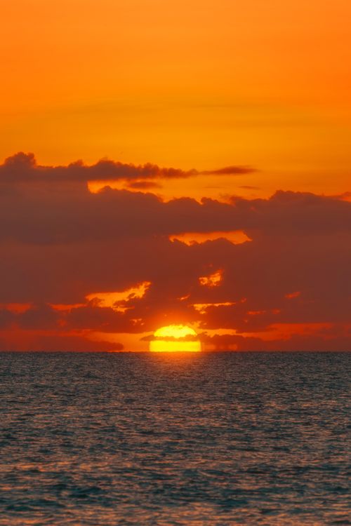 Free Gorgeous sunset at Akumal Beach, casting vibrant colors over the ocean. Stock Photo