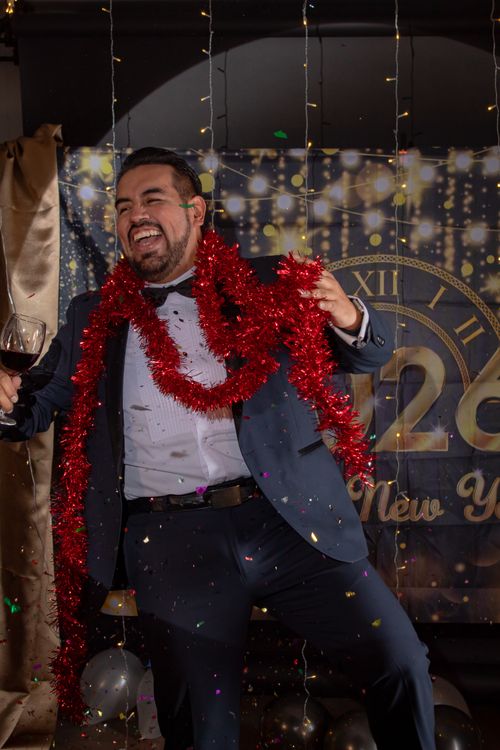 Free Joyful man celebrating New Year's Eve at a party in Mexico, surrounded by decorations. Stock Photo