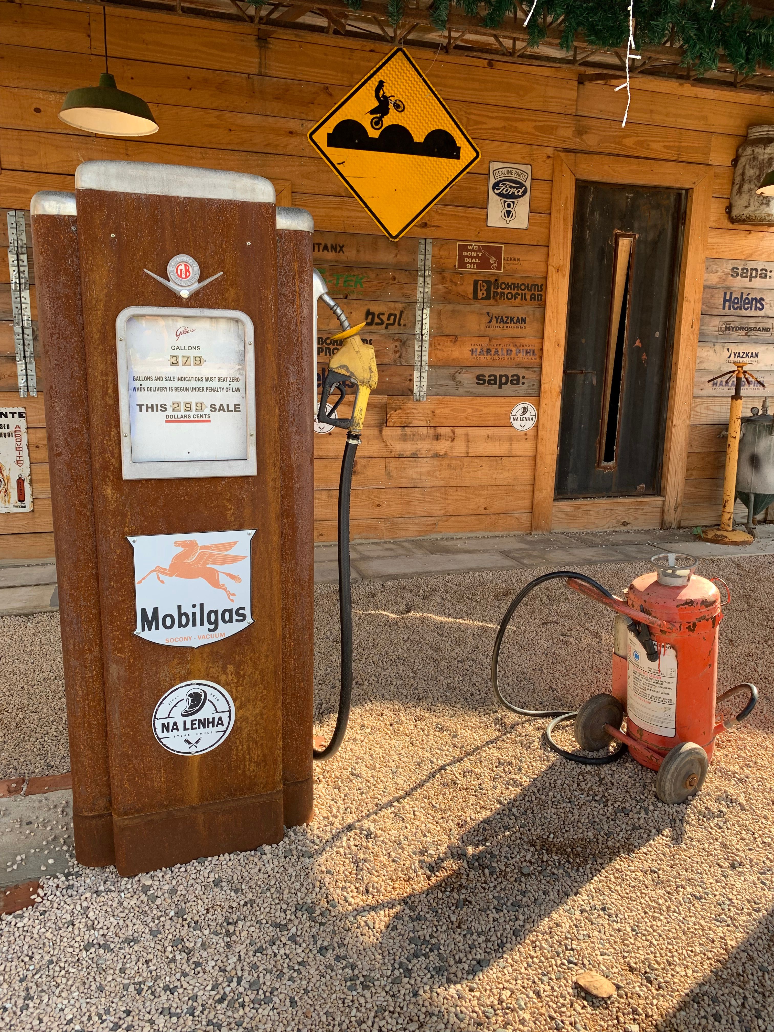 Vintage Rusty Gas Pump with Rustic Signs · Free Stock Photo