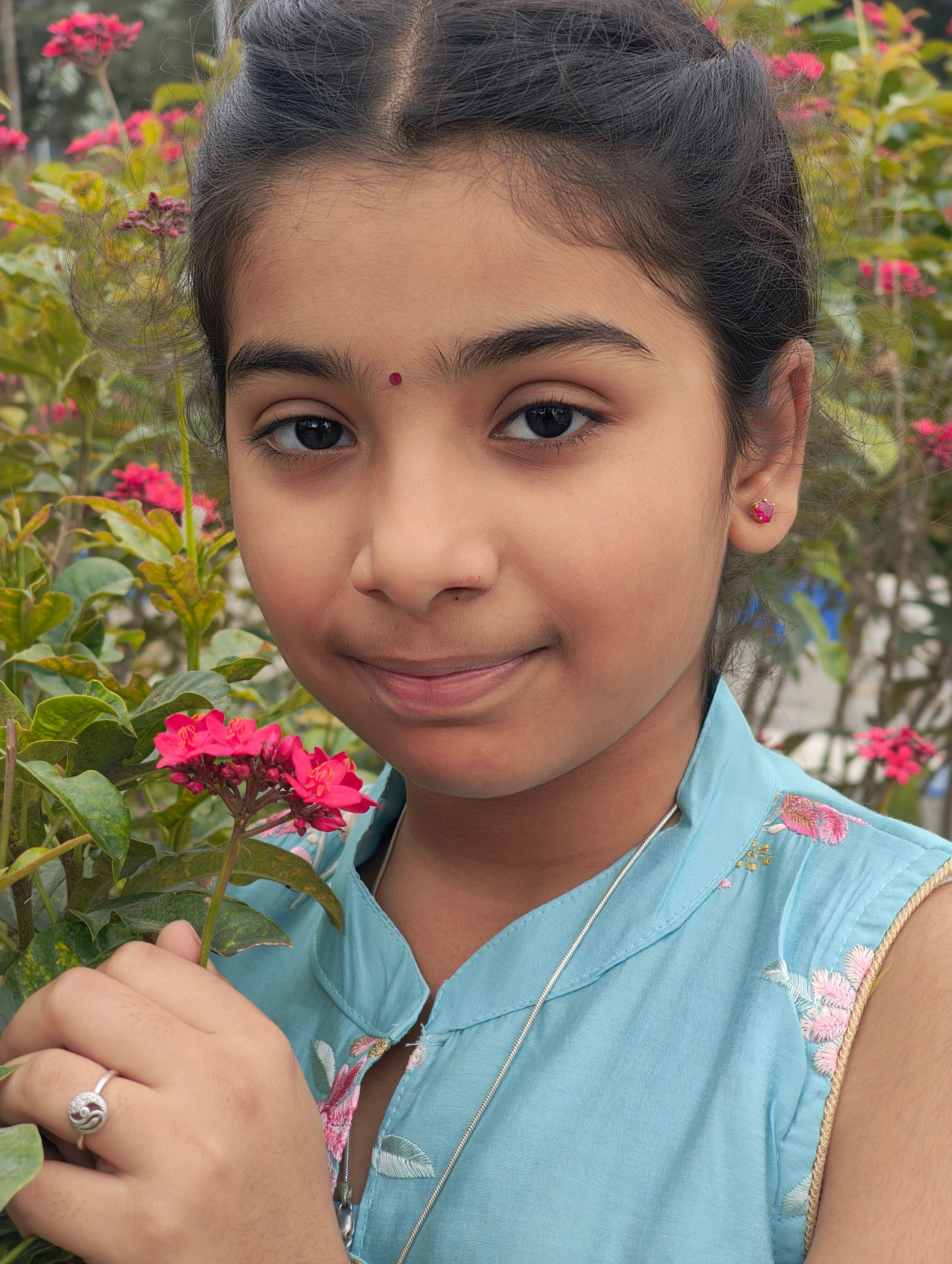 Portrait of a Young Girl with Pink Flowers · Free Stock Photo