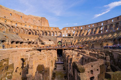 Free Explore the historic ruins of the Colosseum under a bright blue sky in Rome, Italy. Stock Photo