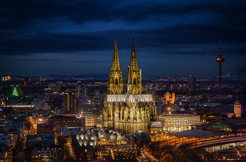 Free Stunning night shot of Cologne Cathedral and cityscape, beautifully illuminated. Stock Photo
