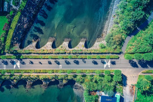 Free Aerial Photography of Road Between Body of Water Stock Photo