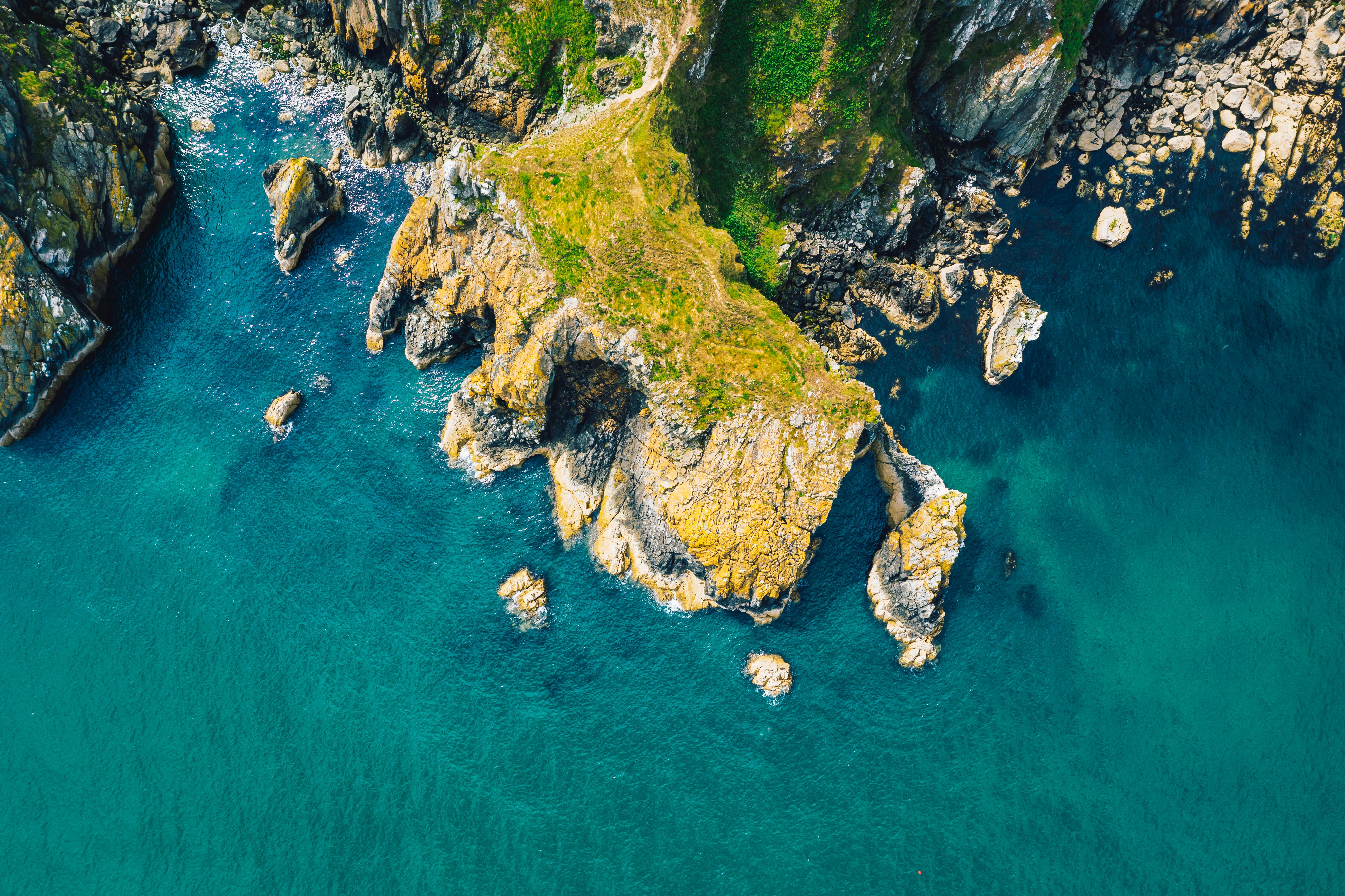 aerial photography of mountain near water