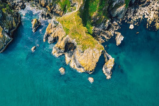 A breathtaking aerial view of Dublin's rugged coastline with vibrant blue waters and rocky cliffs.
