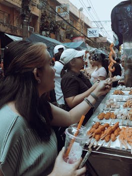 Experience the bustling street food market in Manila, capturing local flavors and vibrant culture.