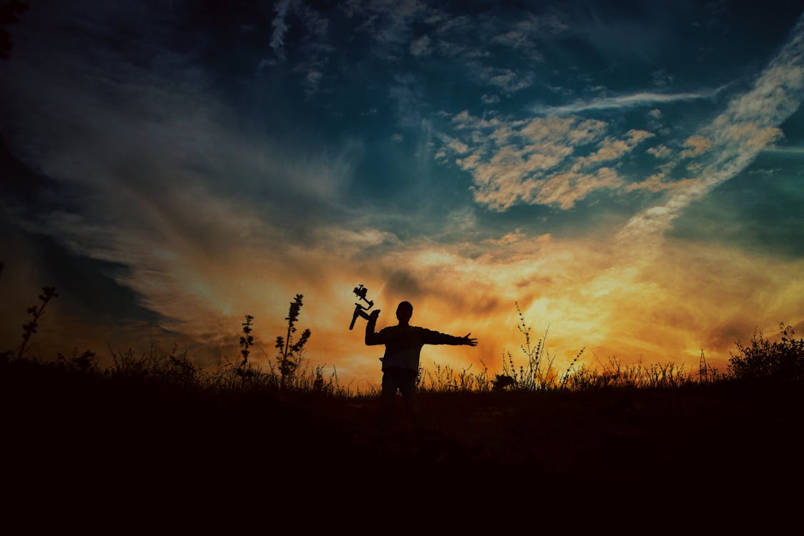 Silhouette of Man on Cliff