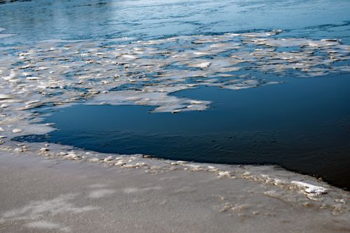 Free A serene winter scene capturing a partially frozen lake with scattered ice sheets in Ingolstadt, Germany. Stock Photo