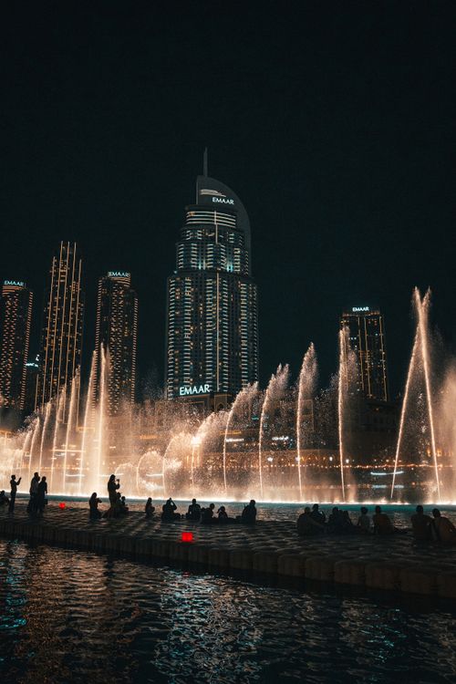 Free A breathtaking view of Dubai's illuminated skyline and fountain show at night, highlighting modern architecture. Stock Photo