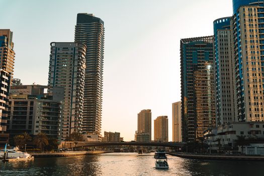 Stunning view of Dubai Marina's modern skyline at sunset, reflecting on the water.