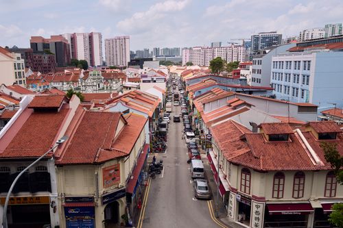 Free Aerial view of a bustling street in Chinatown featuring traditional architecture and red rooftops. Stock Photo